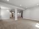 Spacious basement with neutral carpet, white walls and columns, offering a blank canvas for customization at 6877 Northstar Ct, Castle Rock, CO 80108