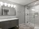 Elegant bathroom featuring a glass shower, marble vanity, and modern lighting fixtures for a luxurious experience at 6877 Northstar Ct, Castle Rock, CO 80108