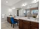 Spacious primary bathroom with double vanity, granite countertop, large mirror, and vanity seating at 6877 Northstar Ct, Castle Rock, CO 80108