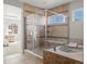 Spacious primary bath features tile surround, glass shower, and soaking tub next to main bedroom at 6877 Northstar Ct, Castle Rock, CO 80108