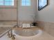 Close-up of bathtub in primary bath showing tile surround, fixtures, tub caddy and decor at 6877 Northstar Ct, Castle Rock, CO 80108