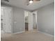 Empty bedroom showcasing multiple doors, neutral walls, light carpet, ceiling fan, and bright natural light at 6877 Northstar Ct, Castle Rock, CO 80108
