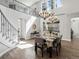 Bright dining room featuring wood floors, a decorative chandelier, and staircase access to a second floor landing at 6877 Northstar Ct, Castle Rock, CO 80108