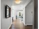 Inviting hallway with hardwood floors and an open floor plan leading into the living area at 6877 Northstar Ct, Castle Rock, CO 80108