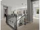 A spacious upper hallway with wrought iron bannister overlooking the home's entry way at 6877 Northstar Ct, Castle Rock, CO 80108