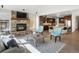 Open concept living space with fireplace, TV, and access to kitchen, perfect for modern living at 6877 Northstar Ct, Castle Rock, CO 80108