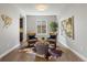 Comfortable living room featuring leather chairs, a decorative cowhide rug, and bright natural light at 6877 Northstar Ct, Castle Rock, CO 80108