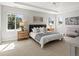 Spacious main bedroom offering three bright windows, tray ceilings, carpet, ceiling fan and decor at 6877 Northstar Ct, Castle Rock, CO 80108