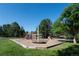 Community playground featuring swings and climbing structures on mulched surface at 6877 Northstar Ct, Castle Rock, CO 80108