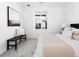 Bedroom featuring a comfortable bed, neutral colors, and bench at 8711 E Hampden Ave # 20, Denver, CO 80231