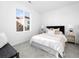 Bright bedroom featuring a large window and white carpet at 8711 E Hampden Ave # 20, Denver, CO 80231