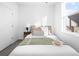 Comfortable bedroom featuring a neutral color palette, soft carpeting, and natural light from a large window at 8711 E Hampden Ave # 20, Denver, CO 80231