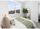 Bright bedroom with a large window offering natural light, complemented by neutral decor and soft carpeting at 8711 E Hampden Ave # 20, Denver, CO 80231