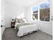 Cozy bedroom with a large window, neutral decor, and soft gray carpeting at 8711 E Hampden Ave # 20, Denver, CO 80231