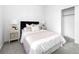 Bright bedroom with a black headboard and two white nightstands at 8711 E Hampden Ave # 20, Denver, CO 80231