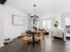 Elegant dining area adjacent to the living room, featuring a stylish light fixture and contemporary decor at 8711 E Hampden Ave # 20, Denver, CO 80231