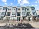 Stylish townhouse exterior with multiple windows, private balconies, and modern design elements at 8711 E Hampden Ave # 20, Denver, CO 80231