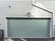 Contemporary gray garage door with house number 26 and modern exterior lighting at 8711 E Hampden Ave # 20, Denver, CO 80231