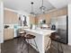 Bright kitchen with stainless steel appliances, a large island, modern cabinets, and stylish pendant lighting at 8711 E Hampden Ave # 20, Denver, CO 80231