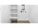 Bright laundry room with storage shelves and hookups for a washer and dryer at 8711 E Hampden Ave # 20, Denver, CO 80231