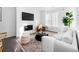 Modern living room featuring a fireplace, large windows, and stylish furniture at 8711 E Hampden Ave # 20, Denver, CO 80231
