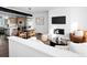 Contemporary living room featuring an open layout, fireplace, dining area, and modern kitchen at 8711 E Hampden Ave # 20, Denver, CO 80231