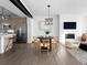 Modern living room featuring a fireplace, dining area, and open concept kitchen with stainless steel appliances at 8711 E Hampden Ave # 20, Denver, CO 80231