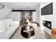 Bright living room with modern decor, fireplace, dining area, and open concept to a sleek kitchen at 8711 E Hampden Ave # 20, Denver, CO 80231