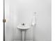 Bright powder room features white walls, pedestal sink, and modern fixtures at 8711 E Hampden Ave # 20, Denver, CO 80231