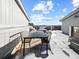 Inviting rooftop deck with seating and dining area covered in a dusting of snow at 8711 E Hampden Ave # 20, Denver, CO 80231
