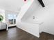 Bright staircase with clean white walls and dark hardwood floors leading to the upper level of the home at 8711 E Hampden Ave # 20, Denver, CO 80231