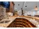 Unique bar with granite countertops, wooden cabinetry, and tile backsplash at 11702 Perry St, Westminster, CO 80031