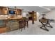 Basement featuring a stone bar with stools, foosball table, and finished ceiling at 11702 Perry St, Westminster, CO 80031