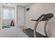 Bright basement gym with carpeted floors, weight rack, yoga mats, and treadmill for at-home fitness at 11702 Perry St, Westminster, CO 80031