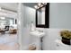 Charming powder room with pedestal sink, wainscoting, and stylish decor at 11702 Perry St, Westminster, CO 80031