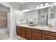 Modern bathroom features double vanity, stone countertops, and tiled shower at 11702 Perry St, Westminster, CO 80031