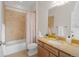 Well-lit bathroom includes a bathtub and shower combination with neutral colored tiles at 11702 Perry St, Westminster, CO 80031