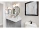 Updated bathroom with stylish vanity, round mirrors, modern fixtures, and natural light at 11702 Perry St, Westminster, CO 80031