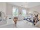 Brightly lit bedroom features plush carpet, two windows, and decorative bed frame at 11702 Perry St, Westminster, CO 80031
