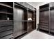 Walk-in closet featuring custom dark wood shelving and hanging racks at 11702 Perry St, Westminster, CO 80031