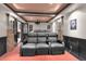 Home theater featuring plush reclining seats, a projector, and stone accent walls at 11702 Perry St, Westminster, CO 80031