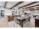Open-concept kitchen and dining area with wood beam ceilings and natural light at 11702 Perry St, Westminster, CO 80031