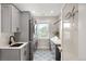 Beautiful laundry room with gray cabinets, patterned tile floor, and modern washer/dryer at 11702 Perry St, Westminster, CO 80031