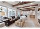 Spacious living room with exposed wood beams, hardwood floors, and an open floor plan at 11702 Perry St, Westminster, CO 80031
