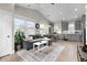 Open-concept living room featuring vaulted ceilings, hardwood floors, and plenty of natural light at 11702 Perry St, Westminster, CO 80031