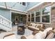 Outdoor patio featuring a fire pit, comfortable seating, and a stone accent wall under string lights at 11702 Perry St, Westminster, CO 80031