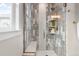 Modern tiled shower with glass door, built-in shelves, and a shower bench at 11702 Perry St, Westminster, CO 80031