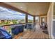 Spacious covered back deck features comfortable seating, a grill, and views of the surrounding neighborhood at 5388 Water Oak Cir, Castle Rock, CO 80108