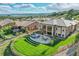 Aerial view of a spacious backyard with a patio, outdoor seating, and manicured lawn at 5388 Water Oak Cir, Castle Rock, CO 80108