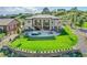 Expansive backyard featuring a lush lawn, patio with fire pit, and terraced landscaping perfect for outdoor enjoyment at 5388 Water Oak Cir, Castle Rock, CO 80108